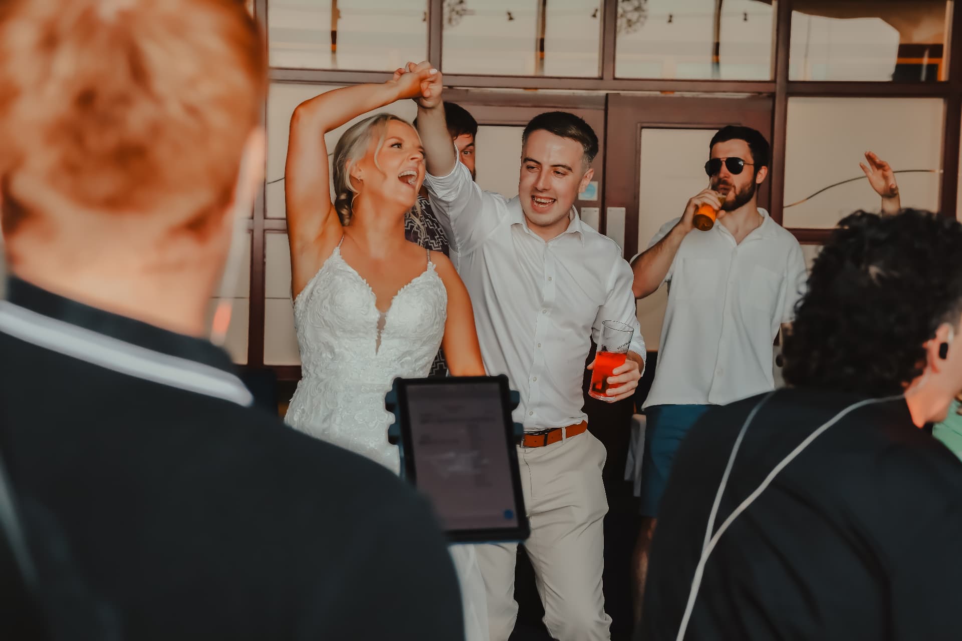 Bride and groom dancing arm in arm during a joyful wedding reception
